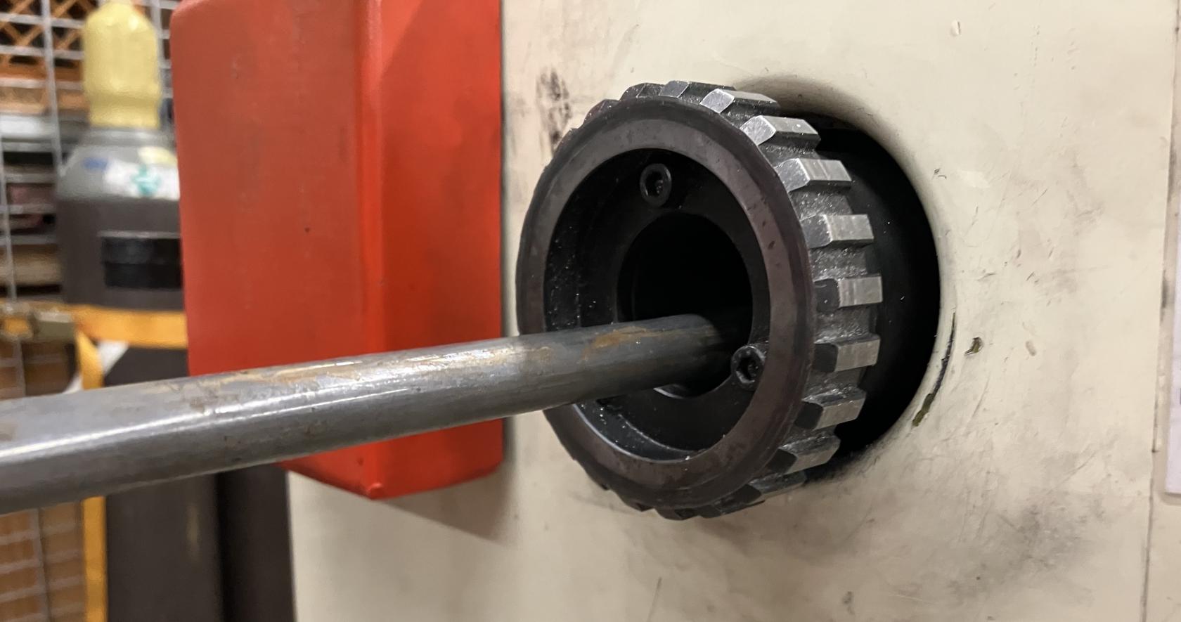 A long workpiece falling off-axis, and uncentered in the back of the headstock.